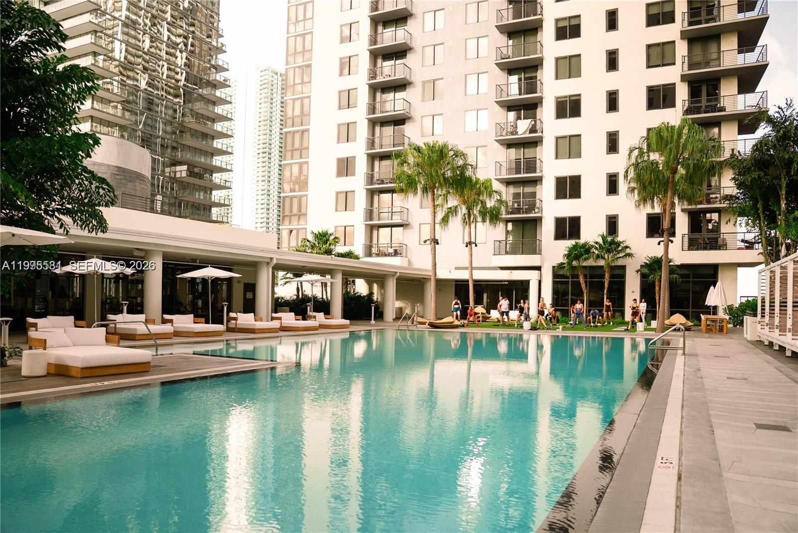 275 Southwest 6th Street, Unit 502 Miami, FL 33130 - Photo 17 of 19 a view of a swimming pool with outdoor seating