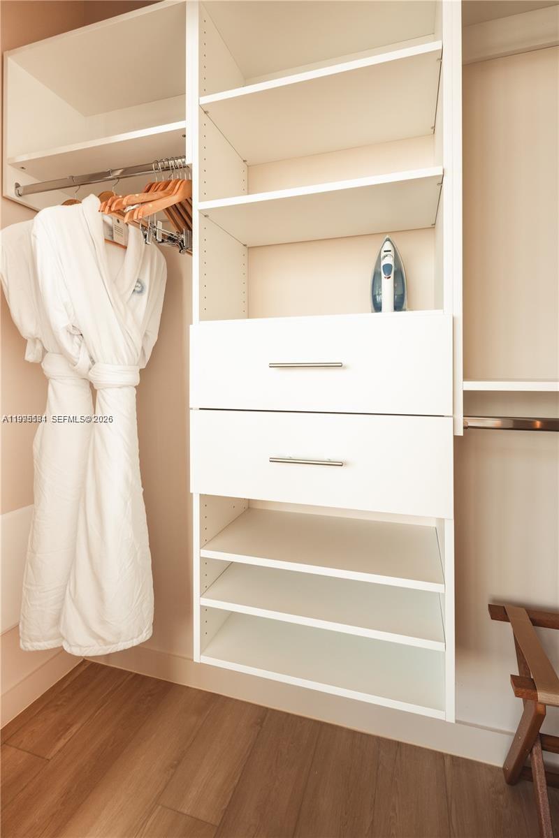 275 Southwest 6th Street, Unit 502 Miami, FL 33130 - Photo 5 of 19 a view of walk in closet with empty racks