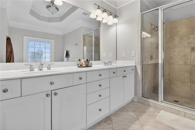 a bathroom with double sink and a mirror