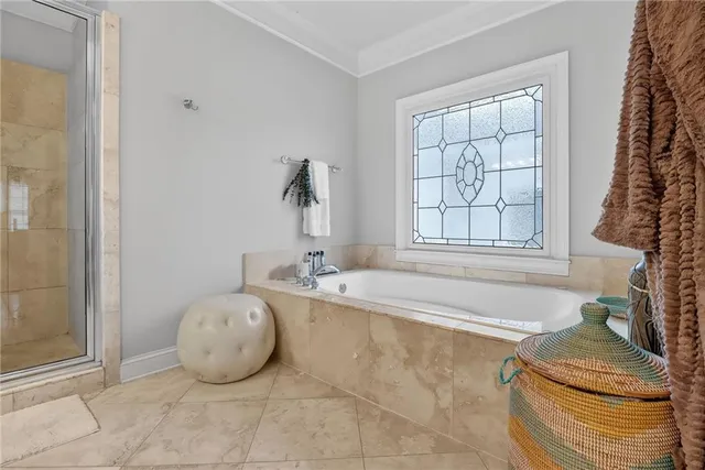 a bathroom with a granite countertop tub sink and mirror