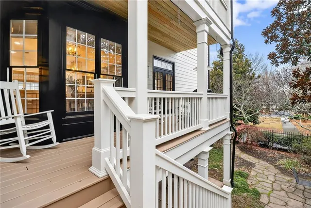 a view of staircase with railing and a potted plant