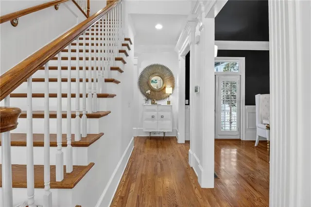 a view of an entryway with wooden floor