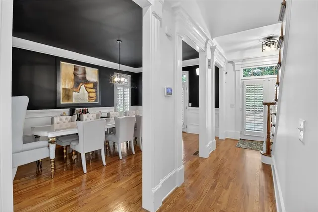 a view of a a dining room with furniture window and wooden floor