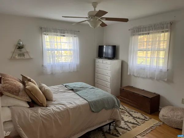 a bedroom with a bed and a television