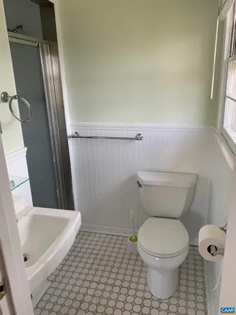a bathroom with a toilet and a shower