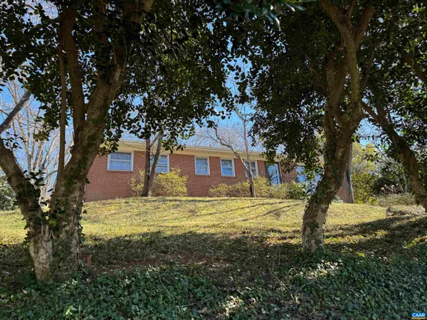 a big house with large trees