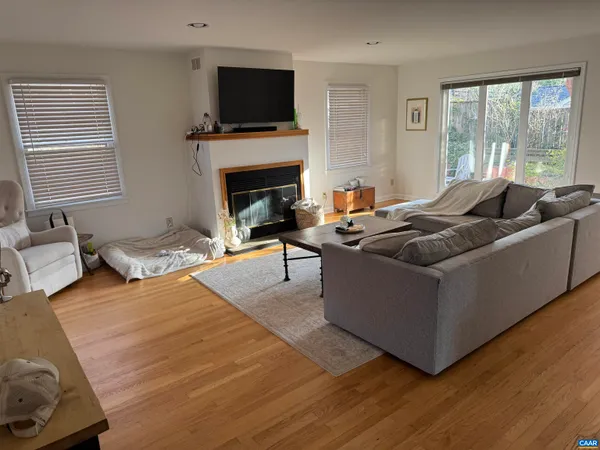 a living room with furniture flat screen tv and a fireplace