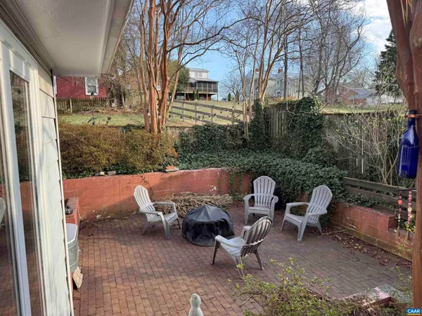 a couple of chairs sitting in backyard of house