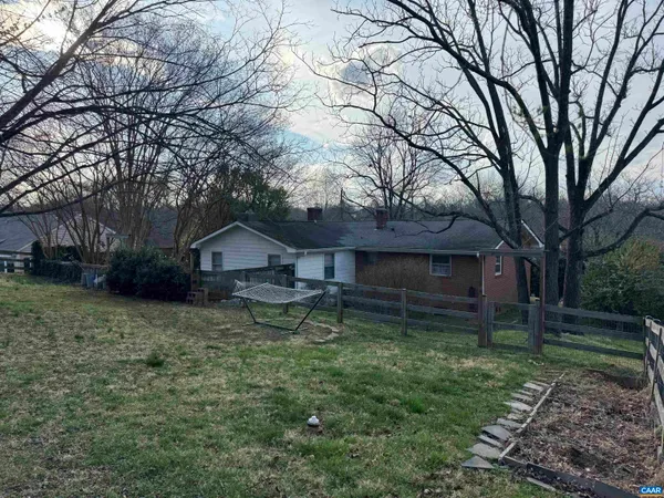 a house is sitting in middle of the forest