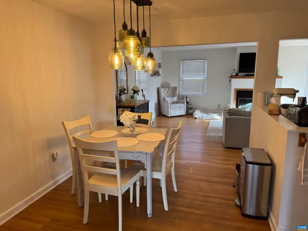 a dining room with furniture and chandelier kitchen view