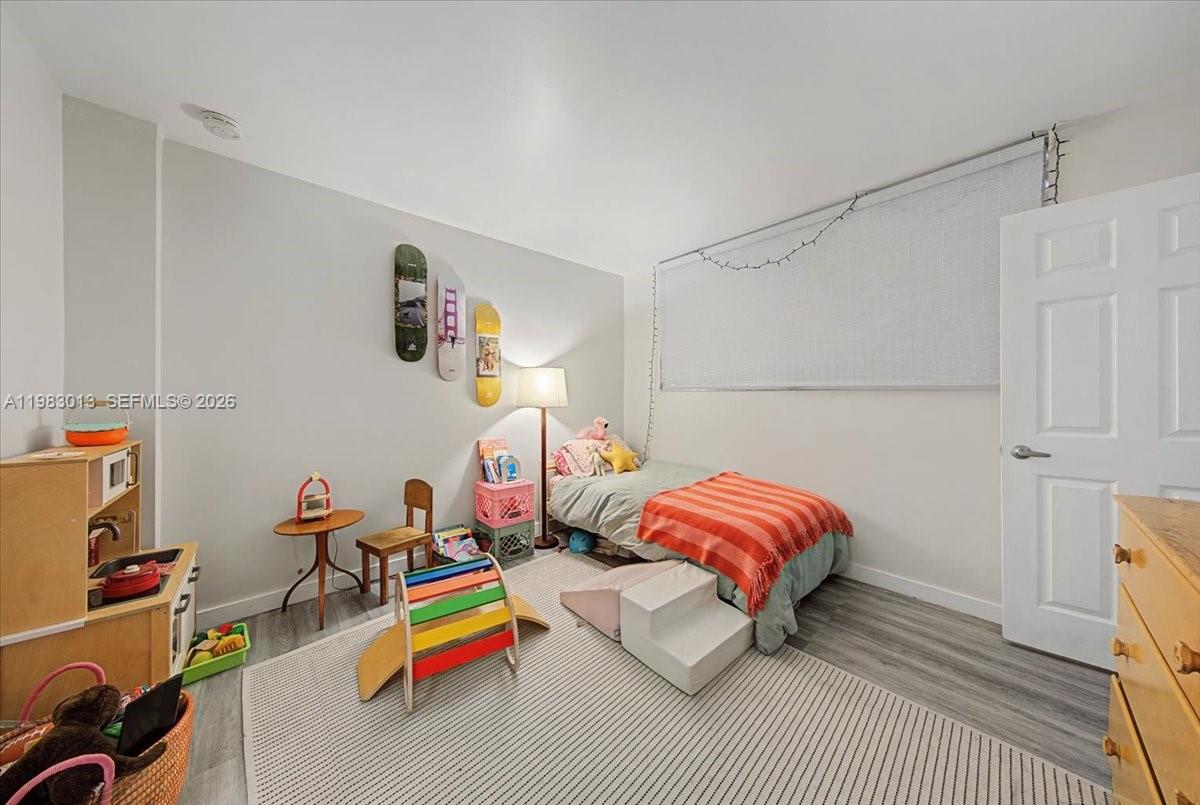 777 Northeast 62nd Street, Unit C211 Miami, FL 33138 - Photo 12 of 22 a bedroom with a bed and a couch