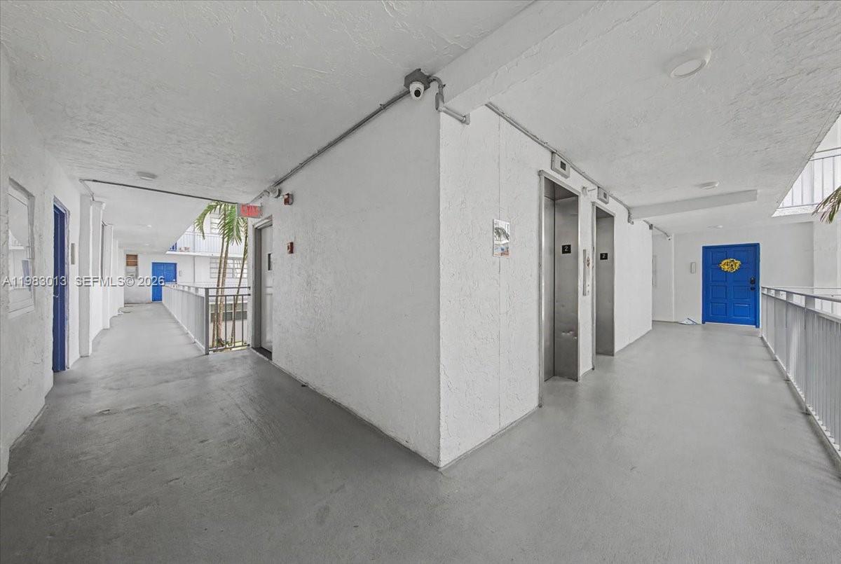 777 Northeast 62nd Street, Unit C211 Miami, FL 33138 - Photo 14 of 22 a view of a hallway with wooden shelves