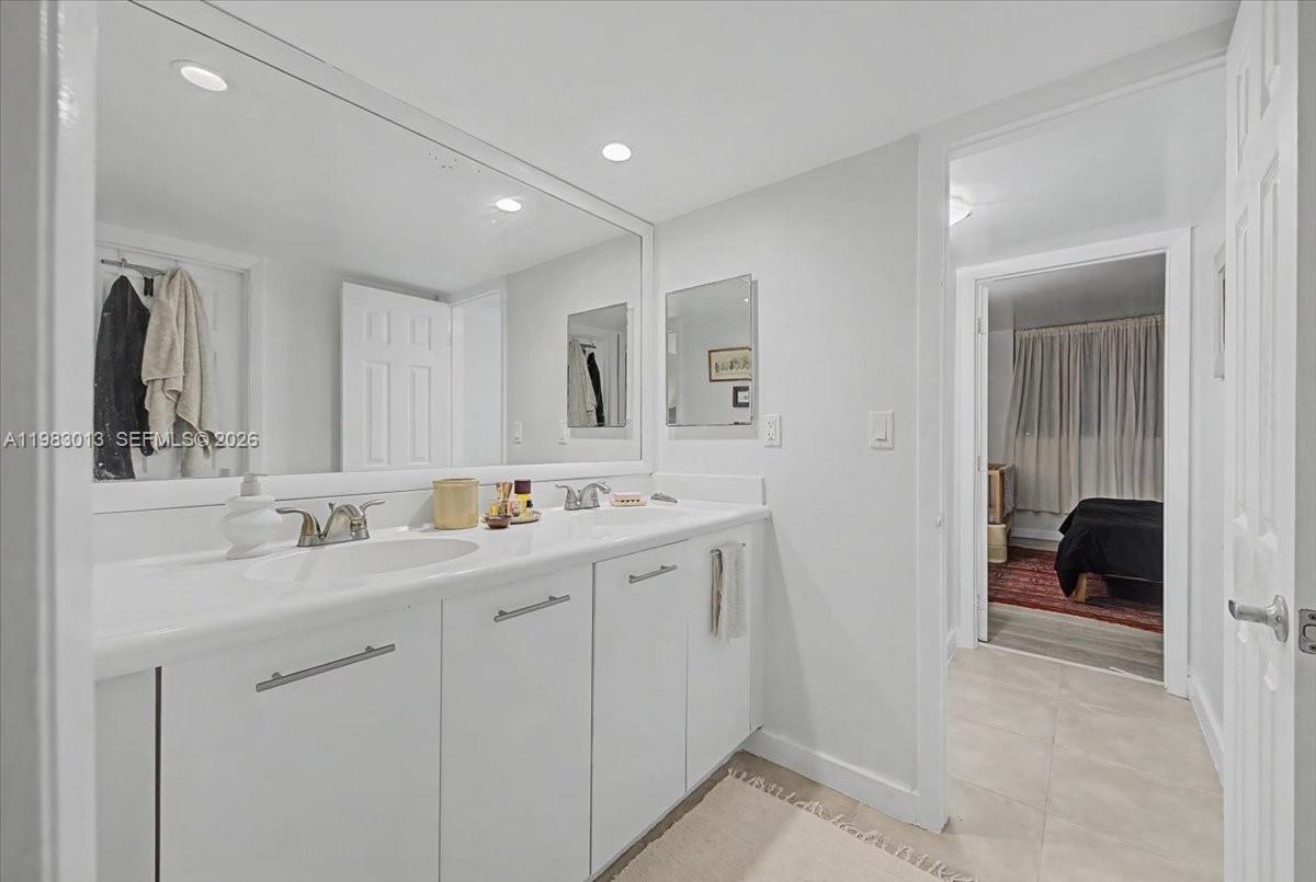 777 Northeast 62nd Street, Unit C211 Miami, FL 33138 - Photo 10 of 22 a en suite bathroom with double sink and mirror