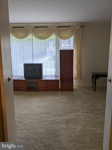 a bedroom with furniture and a large window