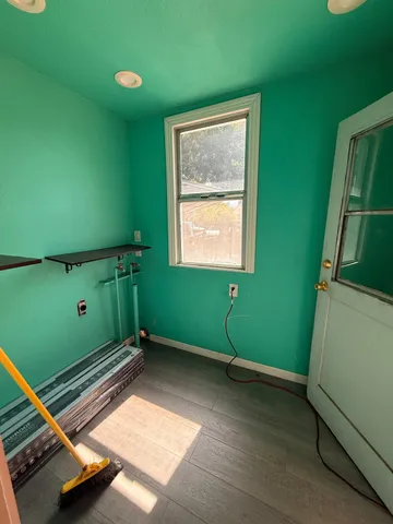a view of a room with wooden floor and cabinet