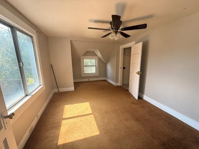an empty room with windows and dryer