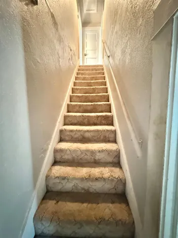 an empty room with windows and entrance