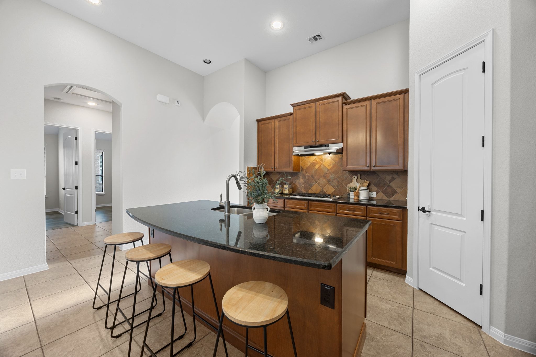1412 Rimstone Drive Cedar Park, TX 78613 - Photo 12 of 39 a kitchen with stainless steel appliances granite countertop a sink a stove counter space and chairs