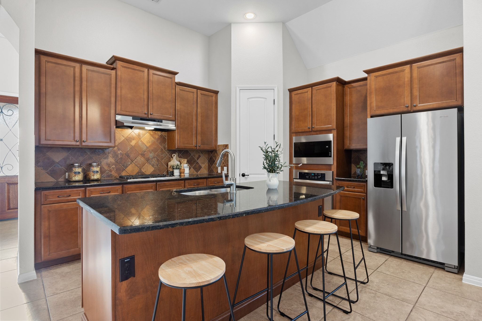 1412 Rimstone Drive Cedar Park, TX 78613 - Photo 13 of 39 a kitchen with stainless steel appliances granite countertop a sink a stove a refrigerator cabinets and chairs