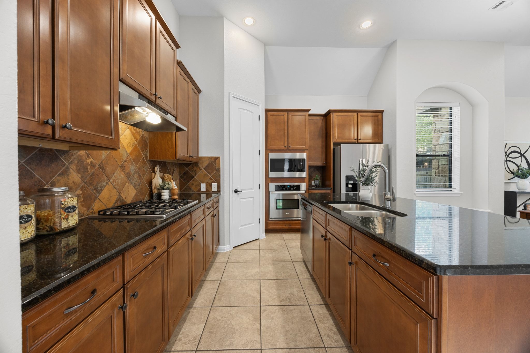 1412 Rimstone Drive Cedar Park, TX 78613 - Photo 9 of 39 a large kitchen with stainless steel appliances granite countertop a stove and a sink