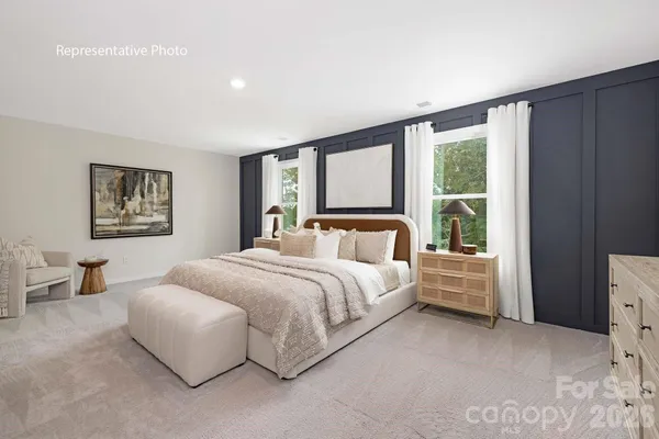 a spacious bedroom with a large bed and a window