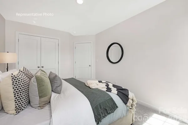 a bedroom with a bed and a potted plant