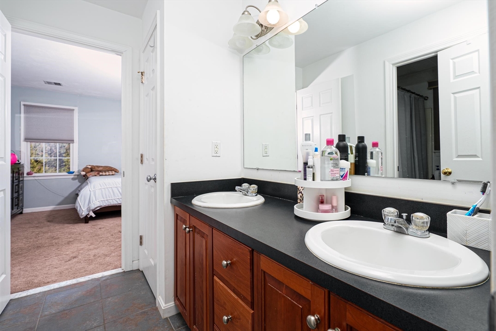 300 Crownshield Avenue Uxbridge, MA 01569 - Photo 20 of 24 a bathroom with a sink double vanity and a mirror