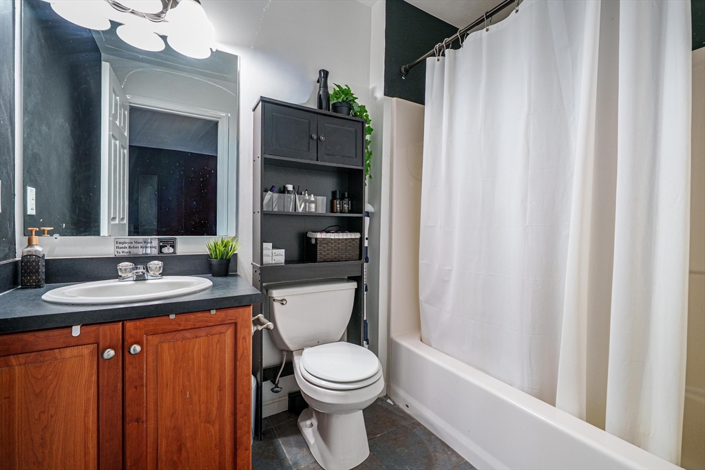 300 Crownshield Avenue Uxbridge, MA 01569 - Photo 22 of 24 a bathroom with a toilet a sink and a mirror