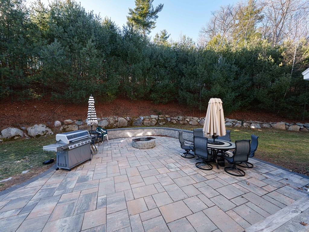 300 Crownshield Avenue Uxbridge, MA 01569 - Photo 23 of 24 a view of a patio with a table and chairs
