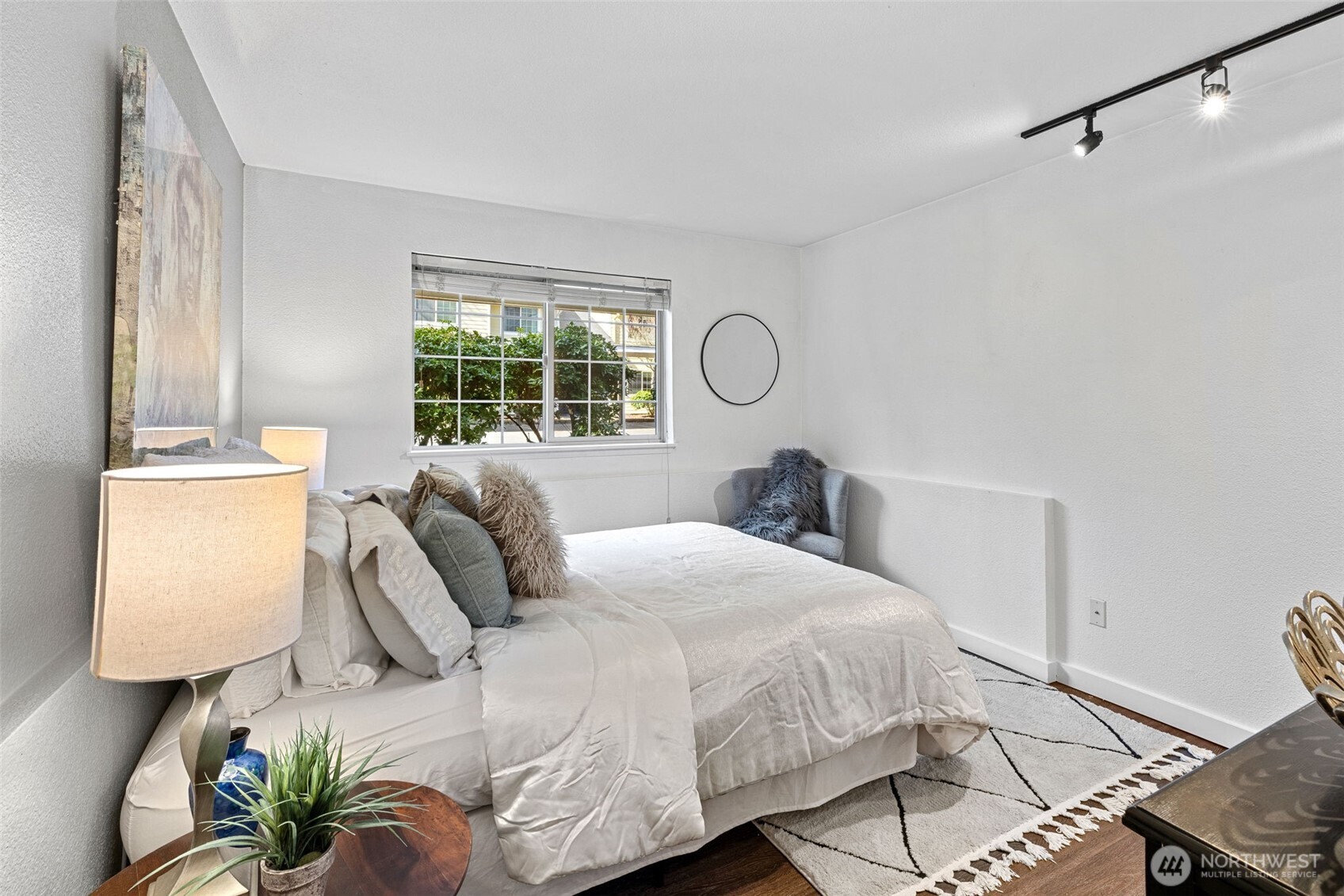 9806 28th Avenue Southwest, Unit A104 Seattle, WA 98126 - Photo 13 of 25 a bedroom with a bed and a window