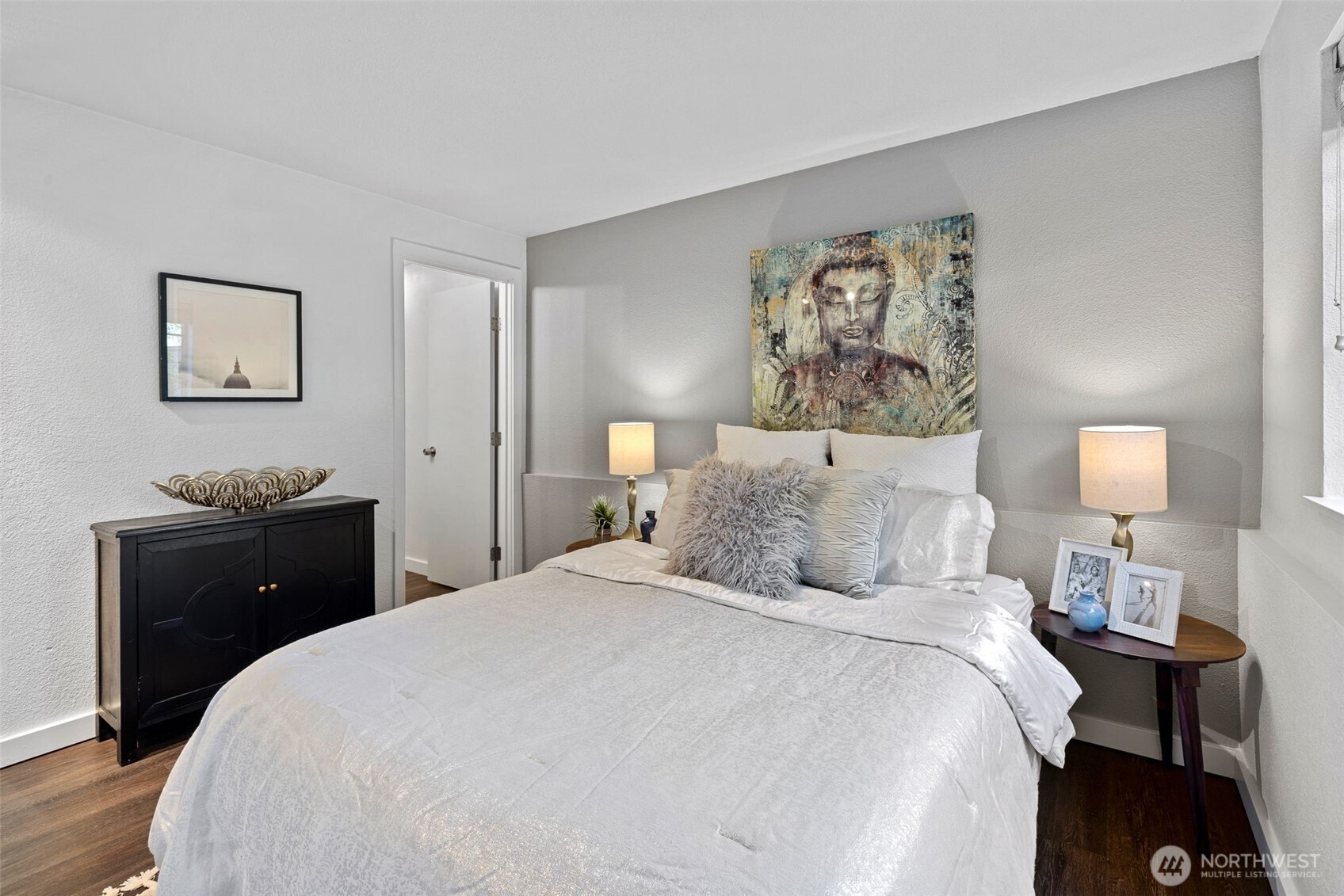 9806 28th Avenue Southwest, Unit A104 Seattle, WA 98126 - Photo 14 of 25 a bedroom with a bed and a lamp on dresser
