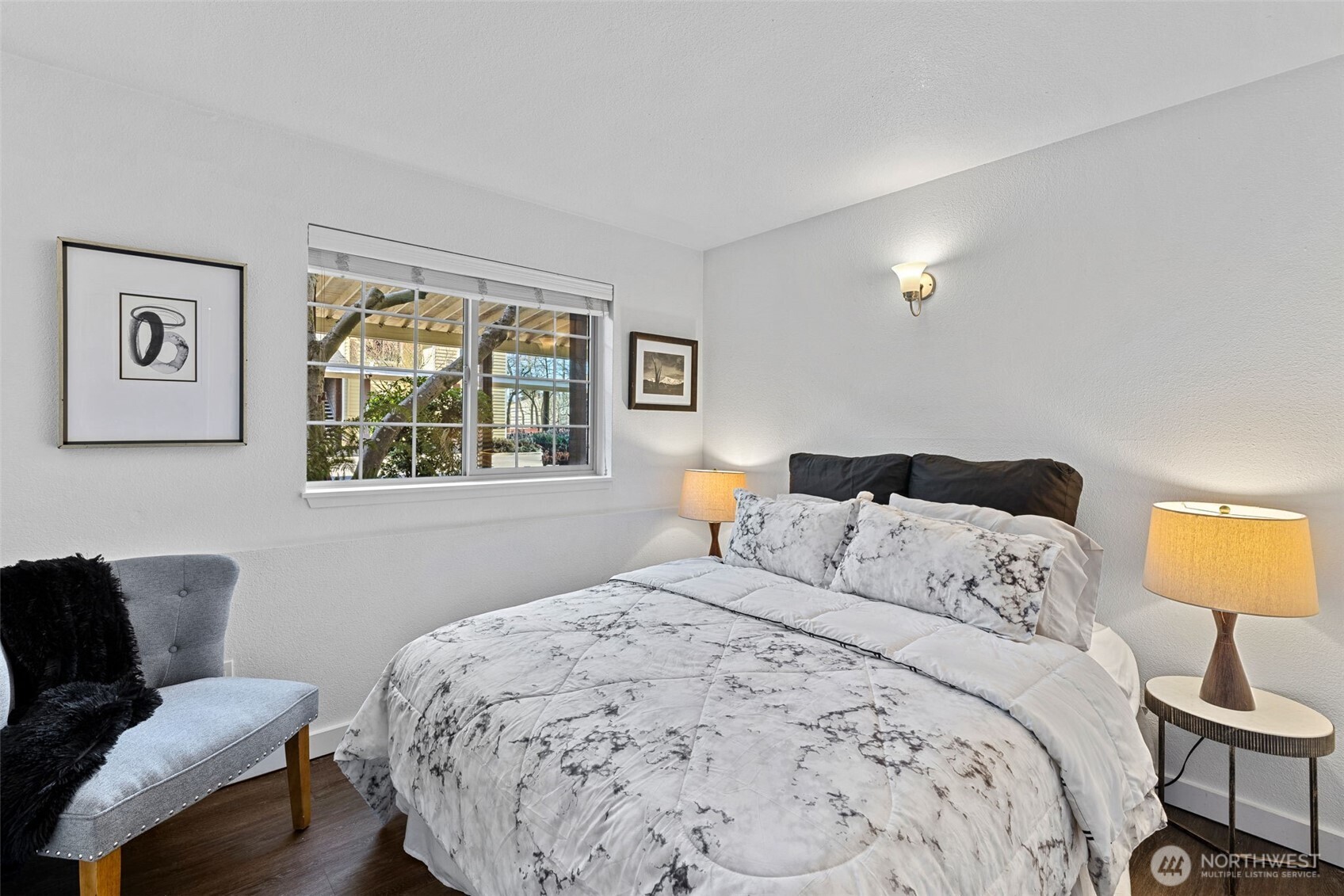 9806 28th Avenue Southwest, Unit A104 Seattle, WA 98126 - Photo 18 of 25 a bedroom with a bed and wooden floor