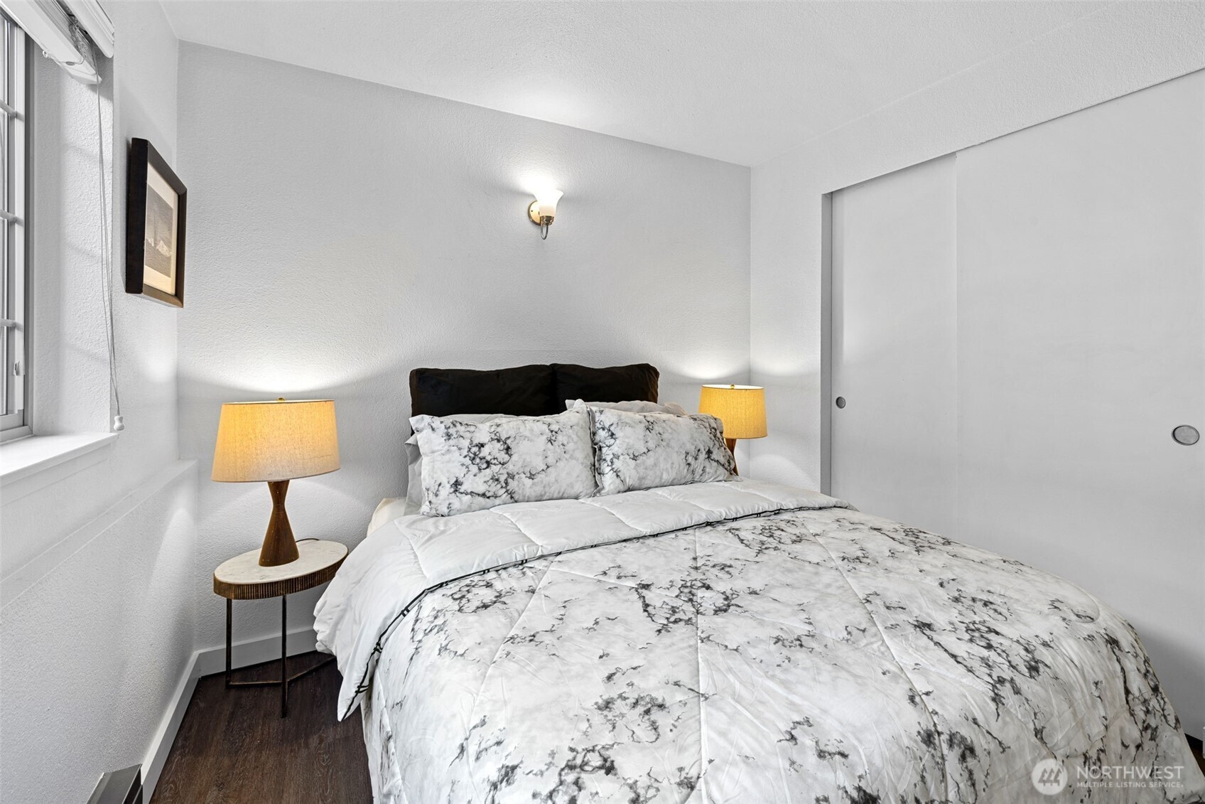 9806 28th Avenue Southwest, Unit A104 Seattle, WA 98126 - Photo 19 of 25 a bedroom with a bed and a lamp