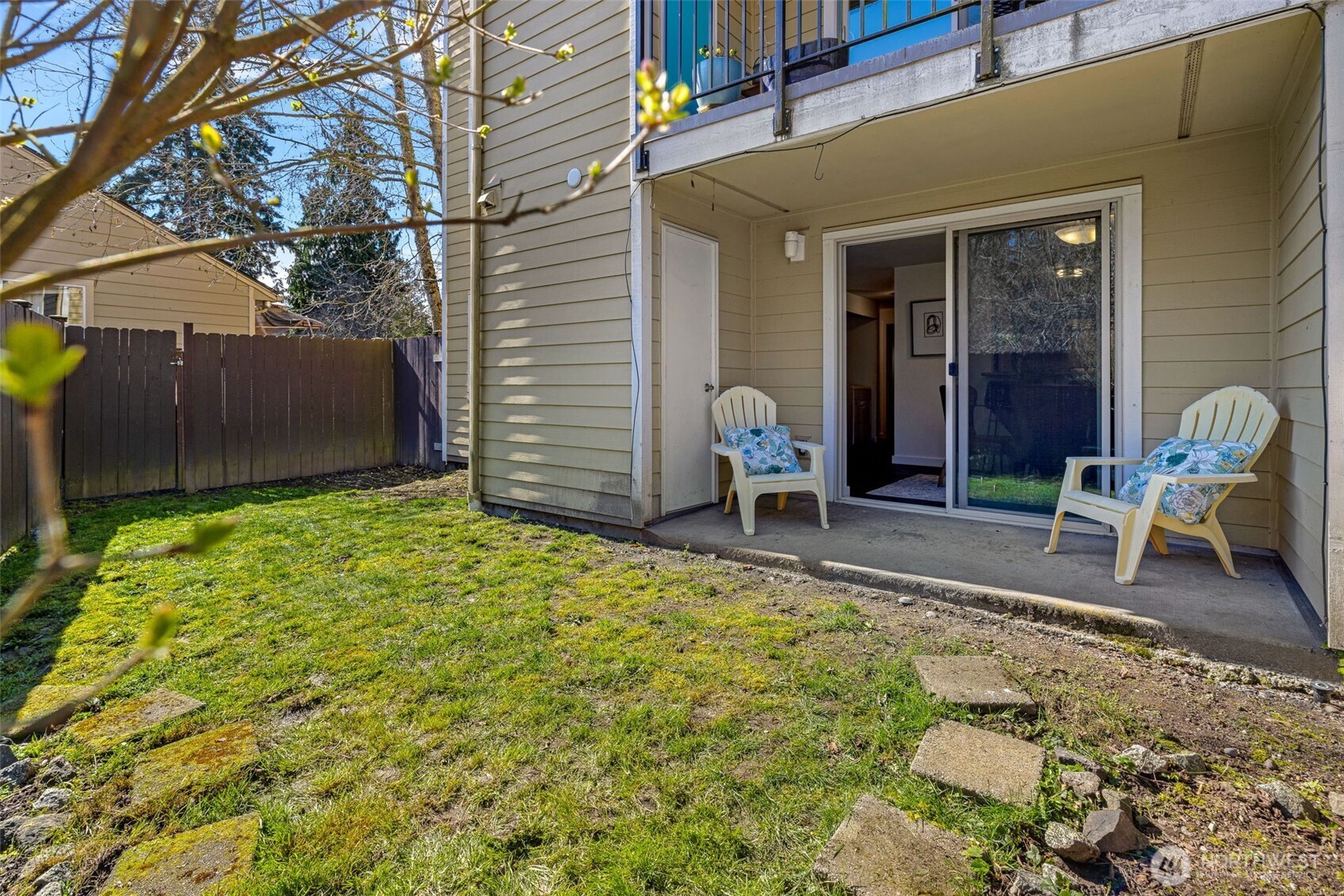 9806 28th Avenue Southwest, Unit A104 Seattle, WA 98126 - Photo 21 of 25 a backyard of a house with table and chairs