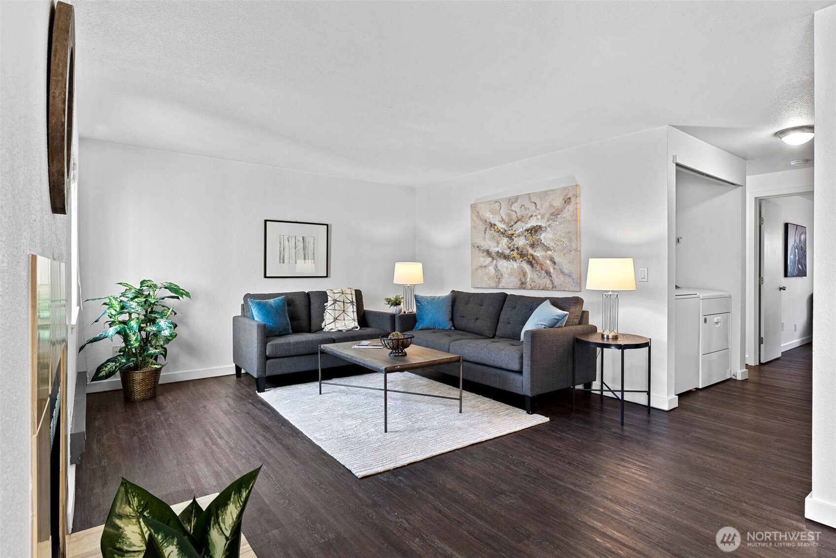 9806 28th Avenue Southwest, Unit A104 Seattle, WA 98126 - Photo 5 of 25 a living room with furniture potted plant and a wooden floor
