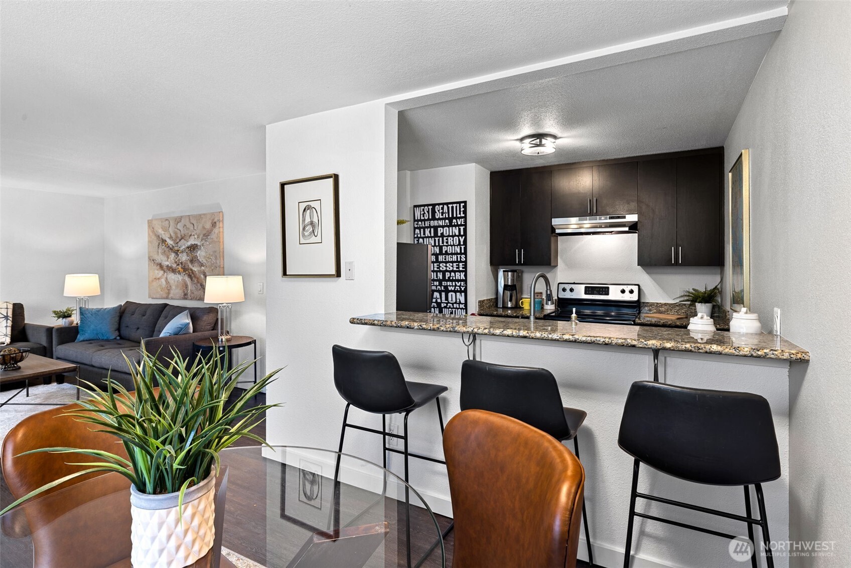 9806 28th Avenue Southwest, Unit A104 Seattle, WA 98126 - Photo 7 of 25 a kitchen with a table chairs and a potted plant