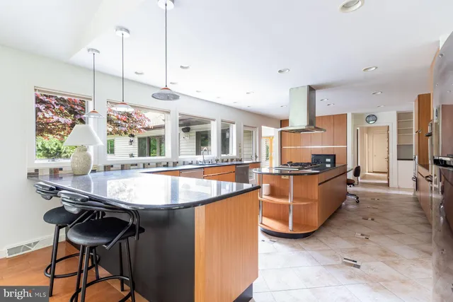 a kitchen with stainless steel appliances granite countertop a sink and a refrigerator