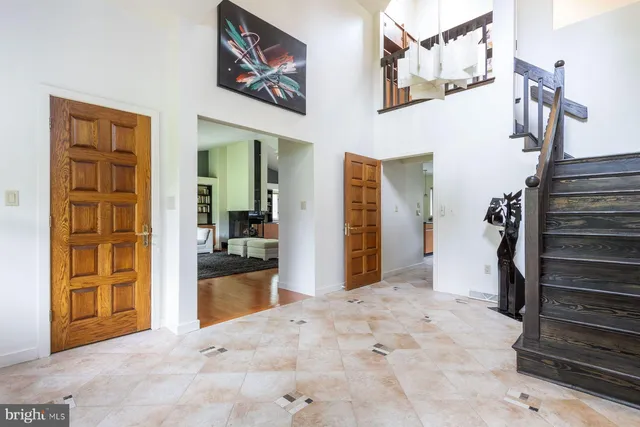 a view of a hallway with wooden floor and entryway