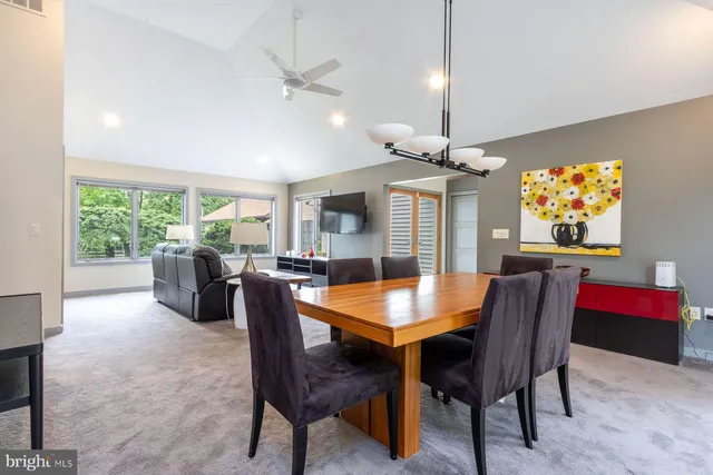 a dining room with furniture a chandelier and window