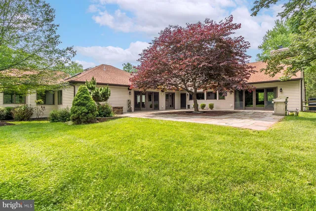 a front view of a house with a yard table and chairs