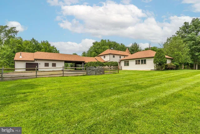 an aerial view of a house with garden space and street view