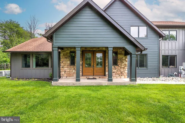 a front view of a house with a yard and porch