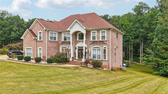 a front view of a house with a yard table and chairs