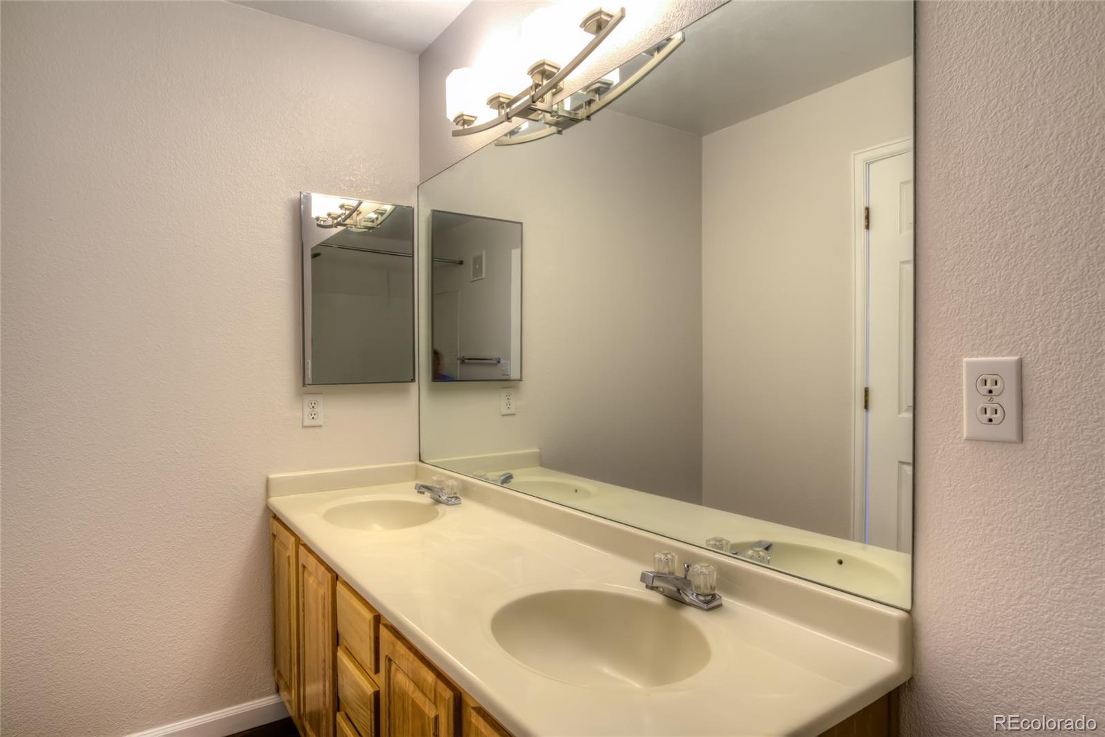 4875 South Balsam Way, Unit 201 Littleton, CO 80123 - Photo 11 of 12 a bathroom with a sink and a mirror