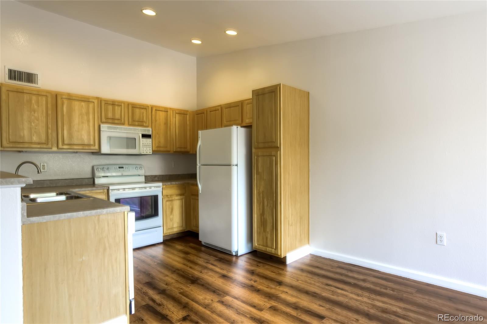 4875 South Balsam Way, Unit 201 Littleton, CO 80123 - Photo 2 of 12 a kitchen with a refrigerator sink and stove