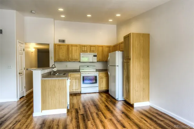 a kitchen with stainless steel appliances a refrigerator and a stove top oven