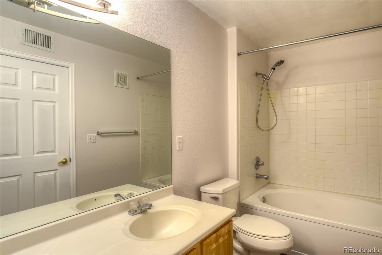 4875 South Balsam Way, Unit 201 Littleton, CO 80123 - Photo 8 of 12 a bathroom with a sink toilet and shower