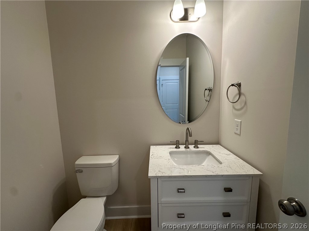 2908 Calloway Road Raeford, NC 28376 - Photo 6 of 25 a bathroom with a toilet sink and mirror