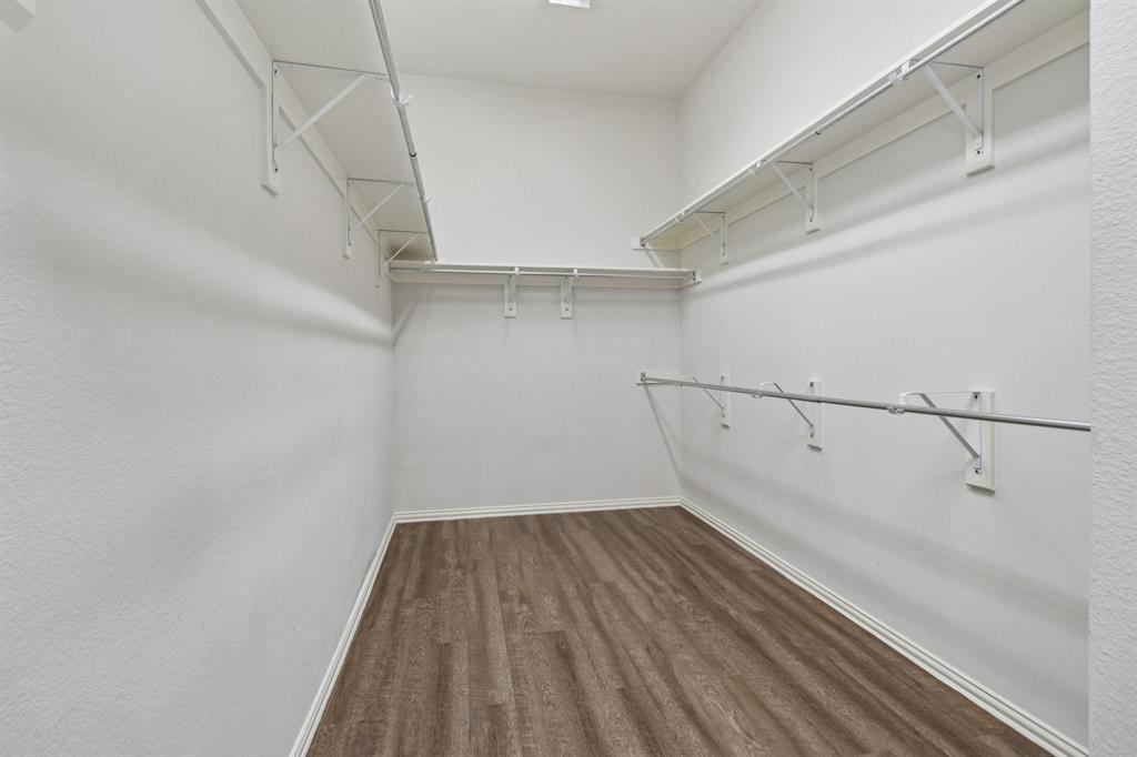 588 Louder Way Fate, TX 75087 - Photo 24 of 34 Spacious closet featuring dark wood-type flooring