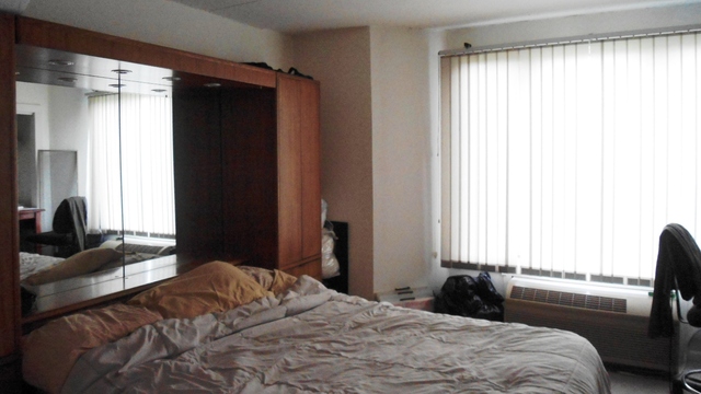 1 Renaissance Place, Unit 915 Palatine, IL 60067 - Photo 6 of 11 a bedroom with a bed and a dresser next to a window